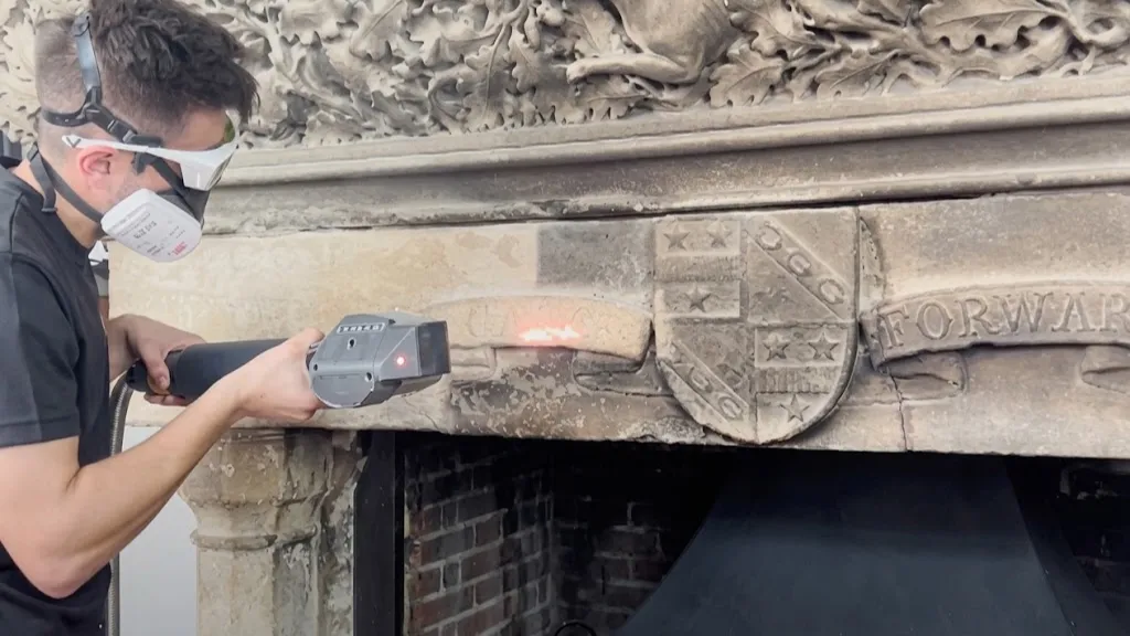 On-site handheld laser cleaning of a building facade without water or chemicals